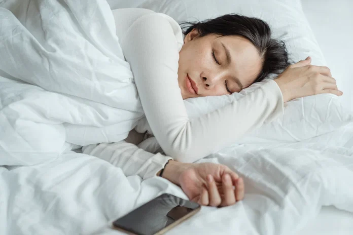 woman-sleeping-in-bed-near-smartphone-4473864-4