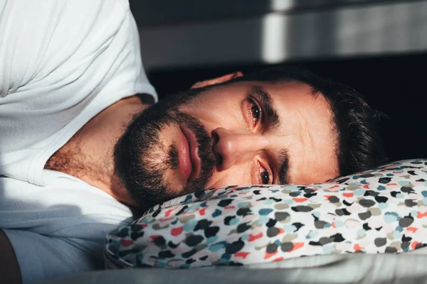depositphotos_241662446-stock-photo-young-depressed-man-crying-bed